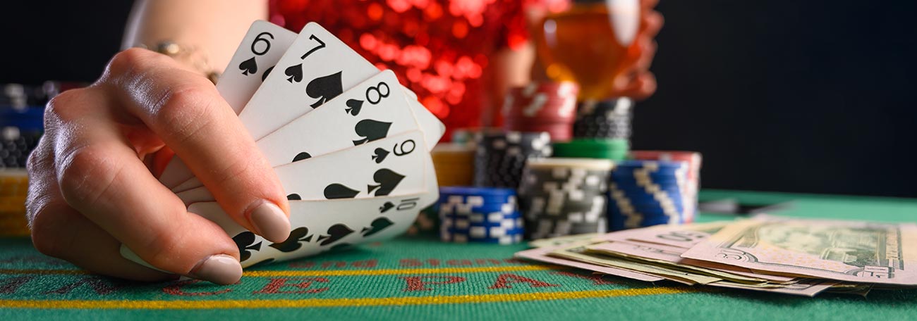 woman showing a straight flush from 6 to 10 in spades