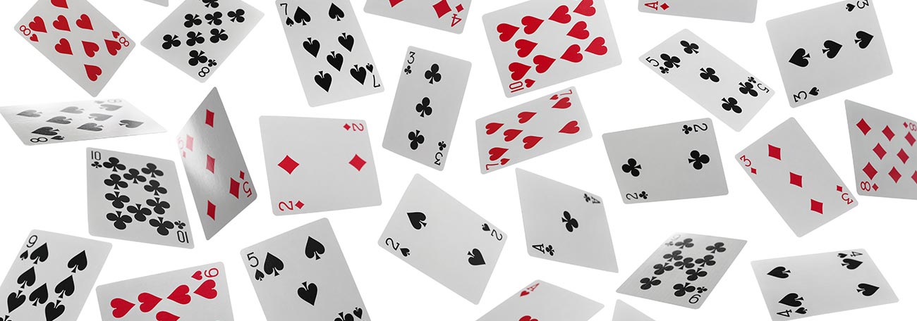 many playing cards floating in the air